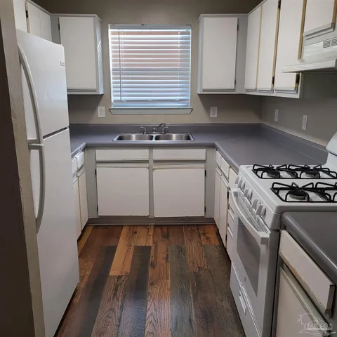 a kitchen with a refrigerator sink and stove