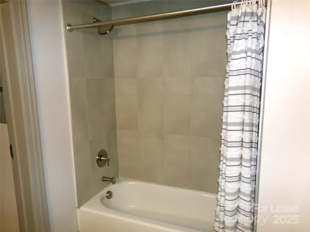 a bathroom with a shower and a bathtub