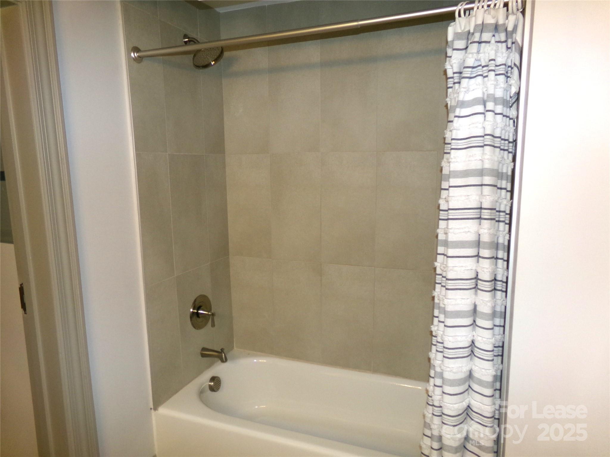 197 North 2nd Street, Unit 5 Albemarle, NC 28001 - Photo 11 of 12 a bathroom with a shower and a bathtub