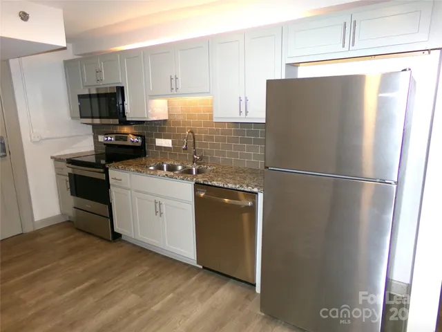 a kitchen with a refrigerator stove and microwave