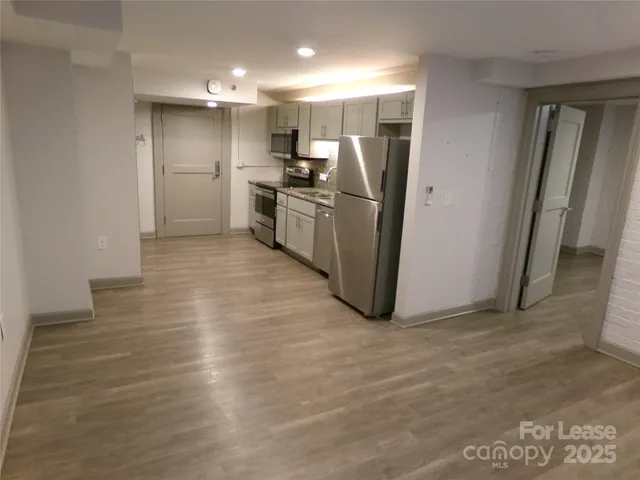 a kitchen with stainless steel appliances a refrigerator and a sink