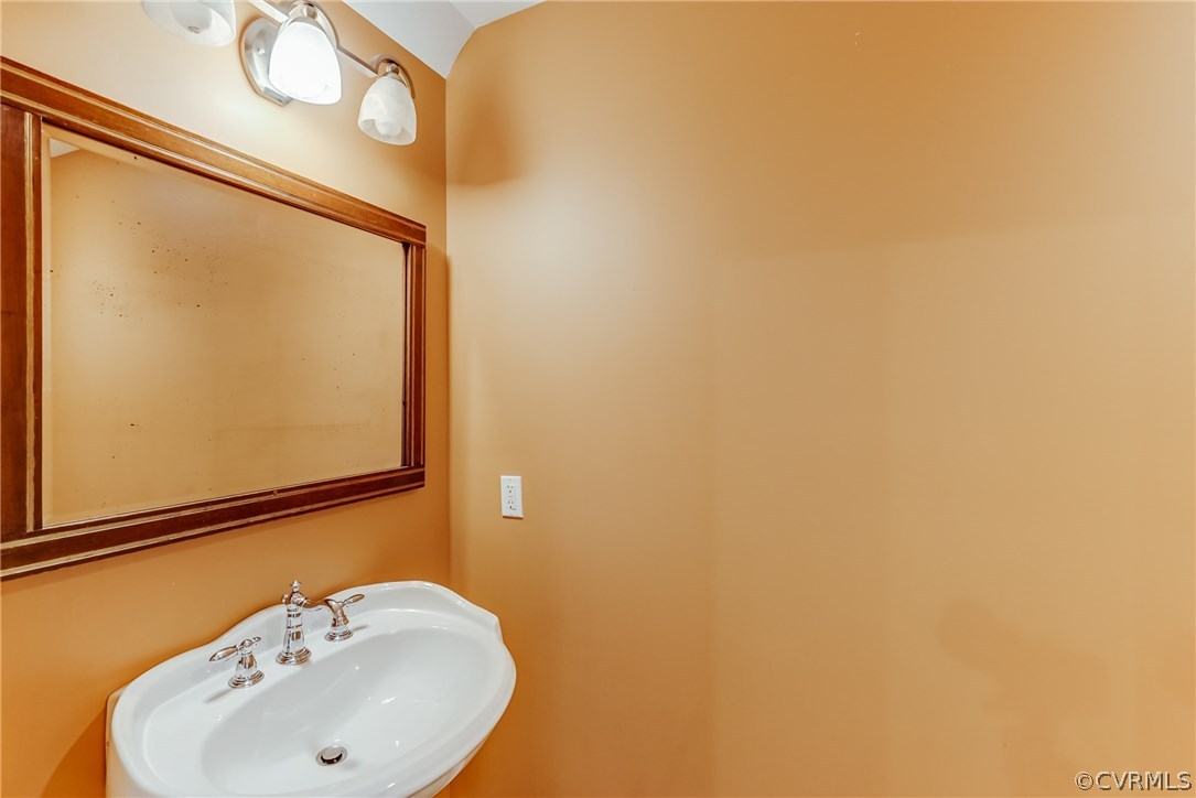 7202 River Road Henrico, VA 23229 - Photo 31 of 49 a bathroom with a sink and mirror