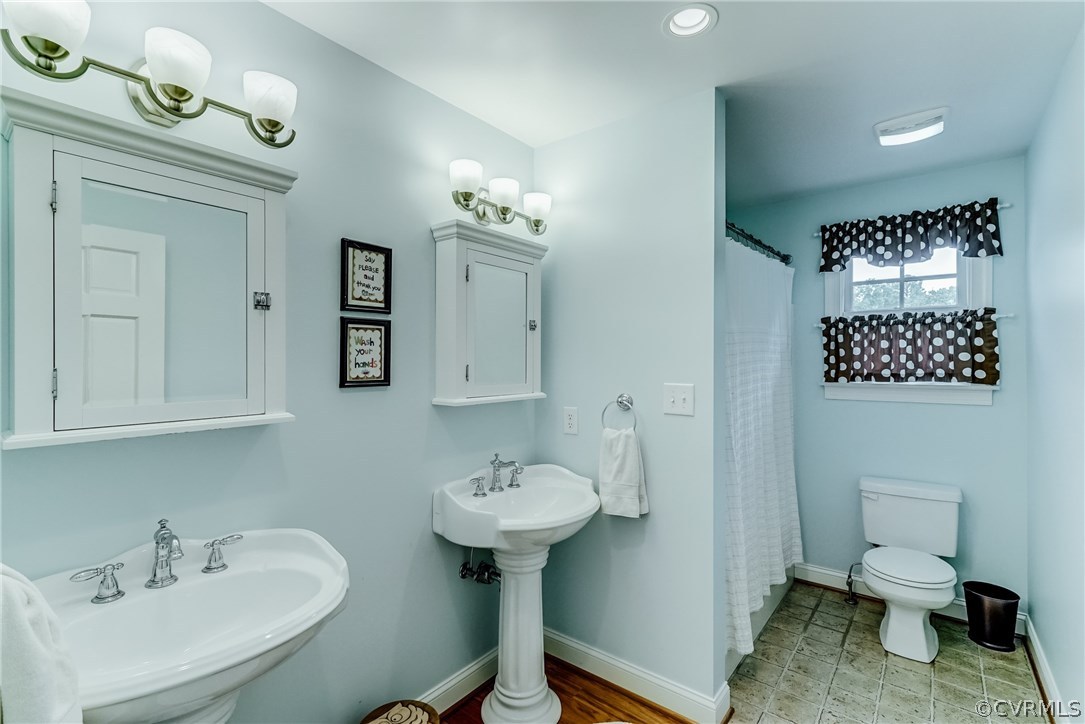 7202 River Road Henrico, VA 23229 - Photo 38 of 49 a bathroom with a sink toilet and a mirror