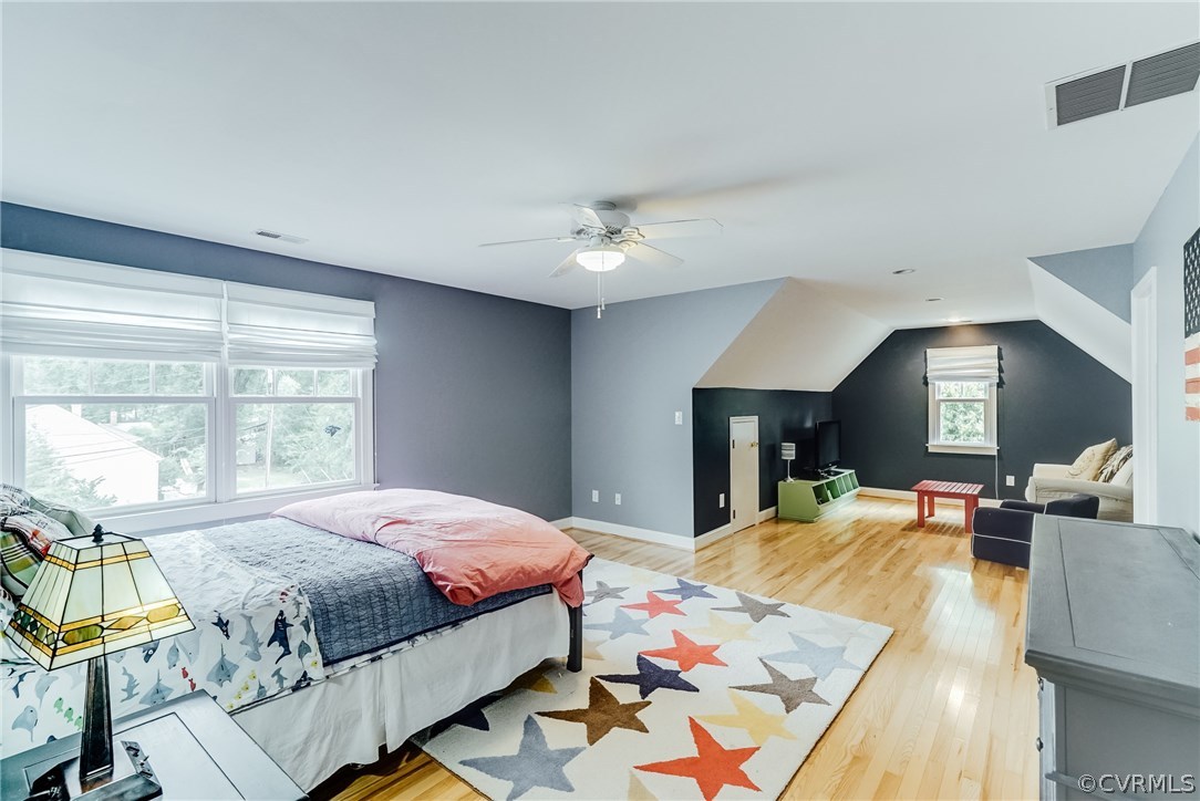 7202 River Road Henrico, VA 23229 - Photo 39 of 49 a large bedroom with a bed a table and painting on the wall