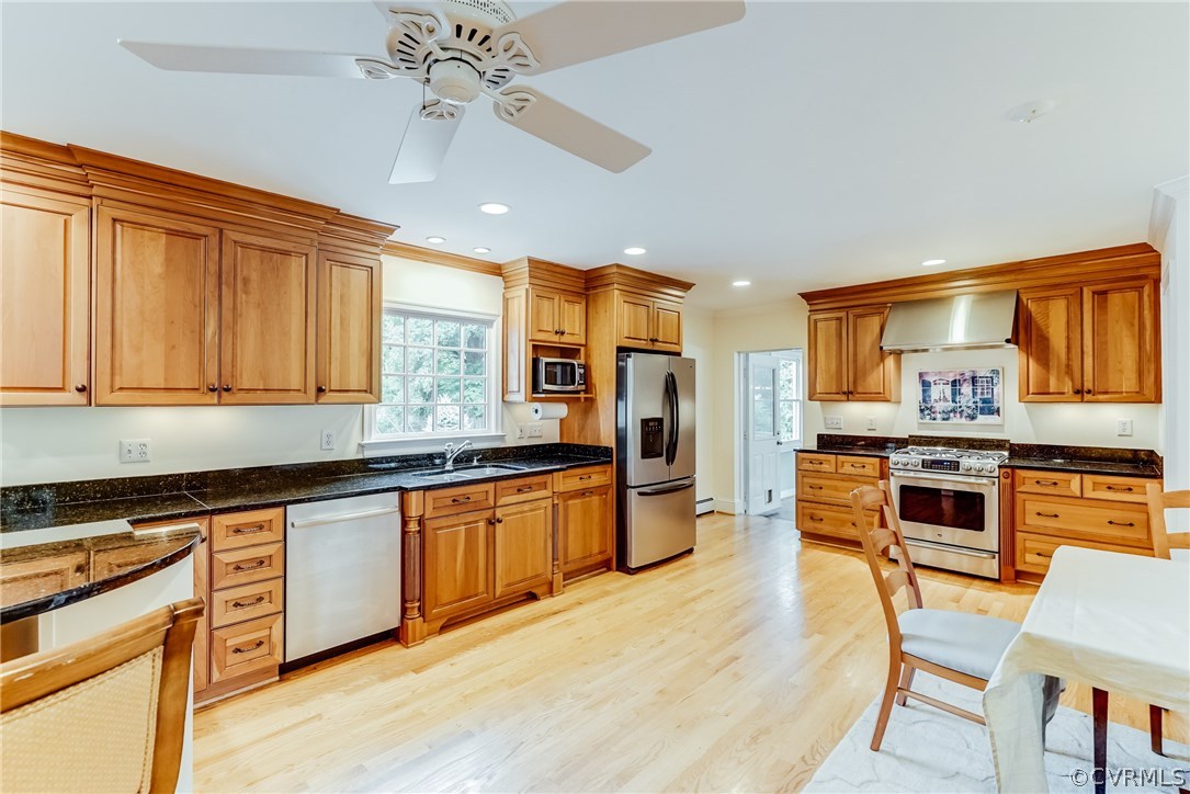 7202 River Road Henrico, VA 23229 - Photo 43 of 49 a kitchen with stainless steel appliances granite countertop wooden cabinets a stove a sink a dining table and chairs