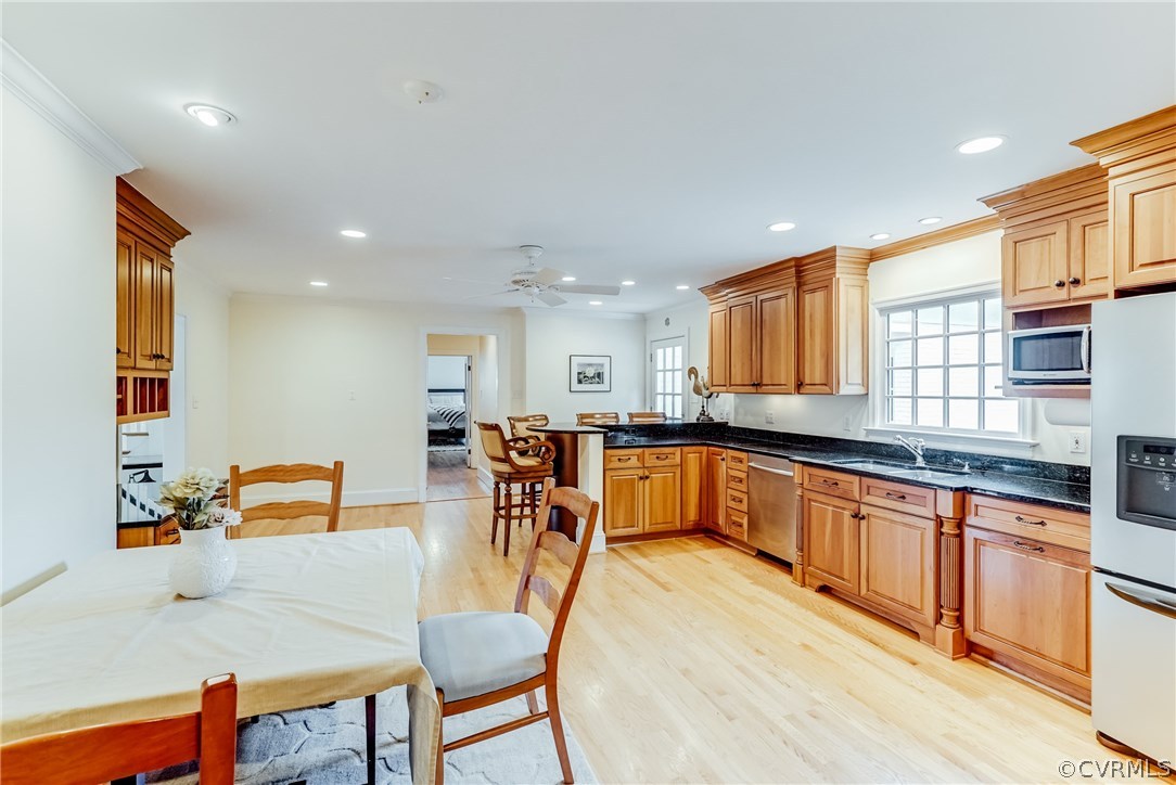 7202 River Road Henrico, VA 23229 - Photo 45 of 49 a kitchen with stainless steel appliances granite countertop a table chairs and a refrigerator