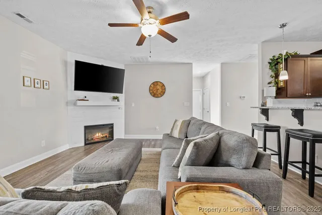 a living room with furniture fireplace and a flat screen tv