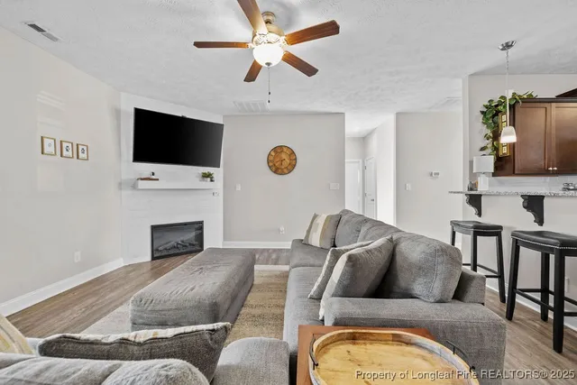 a living room with furniture fireplace and a flat screen tv