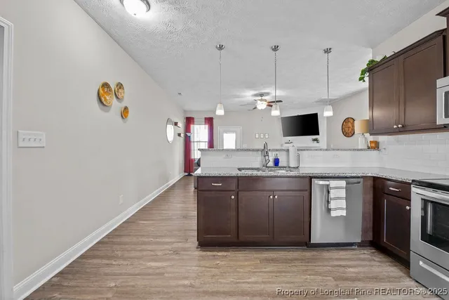 a kitchen with a sink cabinets and wooden floor