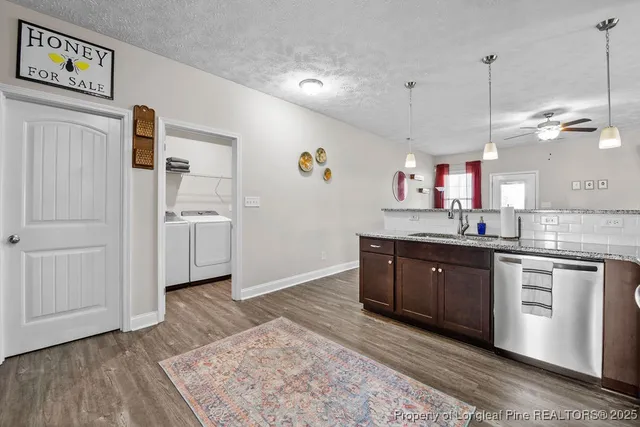 a kitchen with a refrigerator sink and cabinets