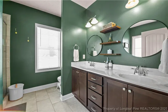 a bathroom with a double vanity sink and a mirror