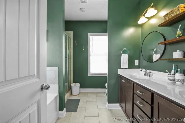 a bathroom with a double vanity sink mirror and toilet