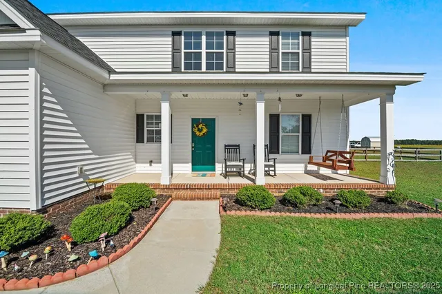 a front view of a house with porch and outdoor seating
