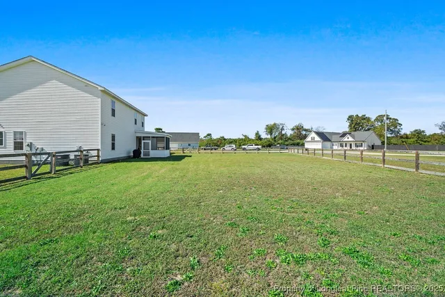 a backyard of a house with lots of green space and garden