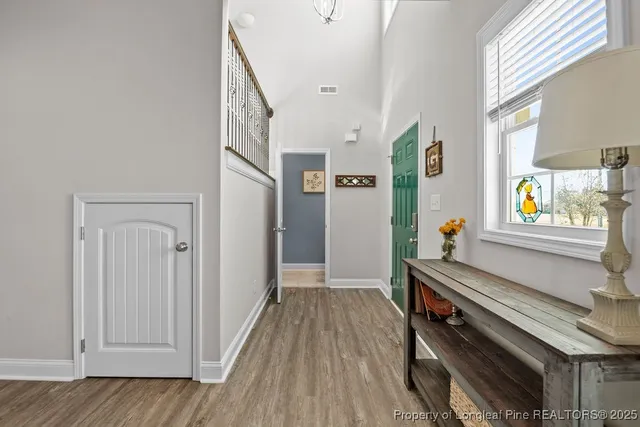 a view of an entryway with wooden floor