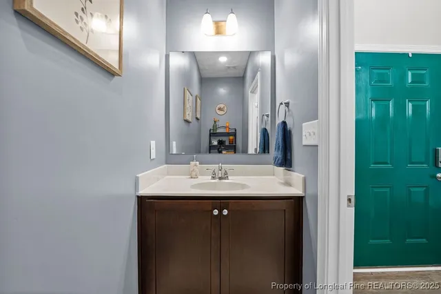 a bathroom with a granite countertop sink and a mirror