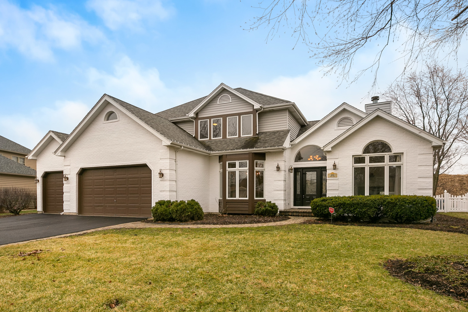 a front view of a house with a yard and garage