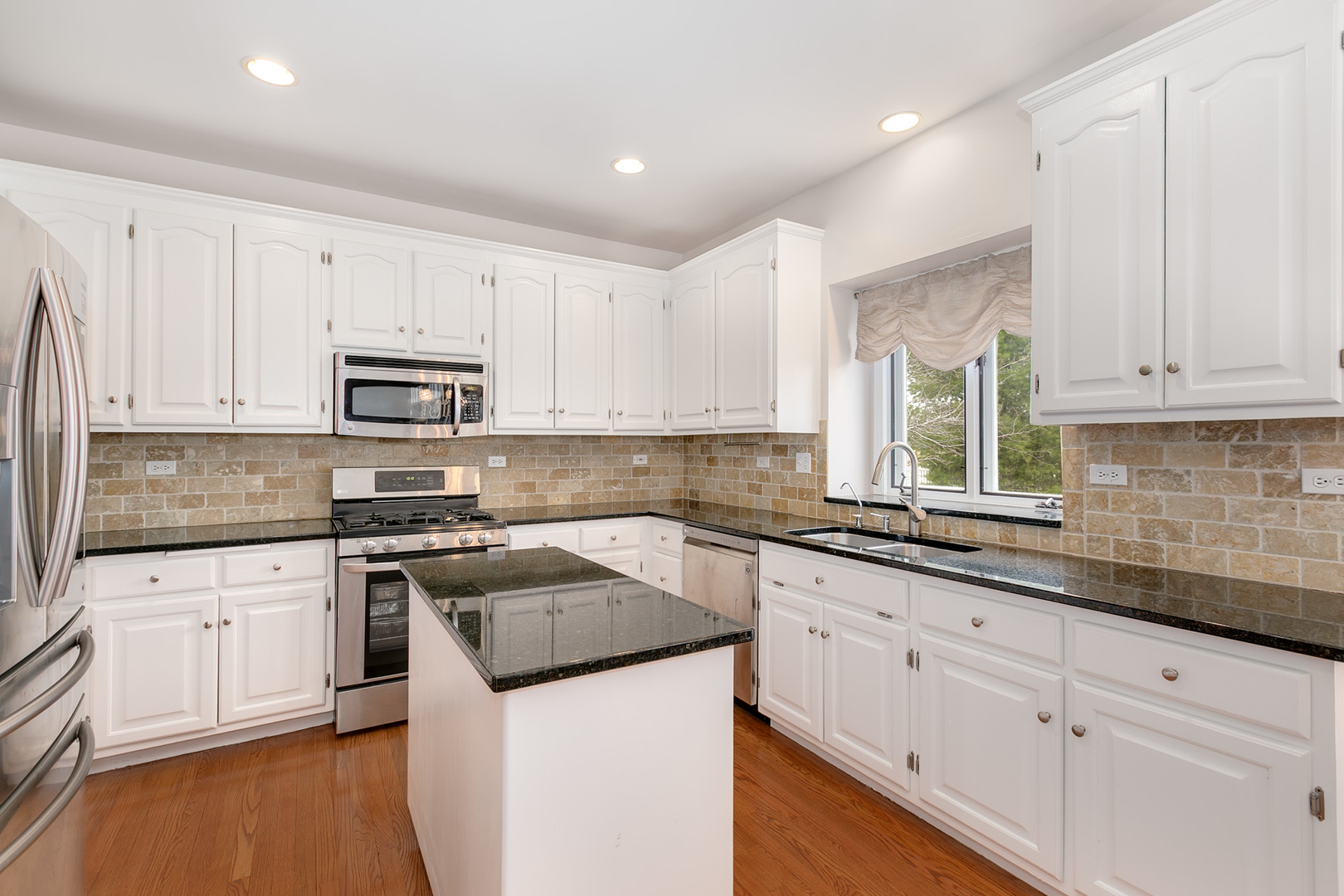 464 Lewis Road Geneva, IL 60134 - Photo 11 of 33 a kitchen with granite countertop white cabinets and white appliances