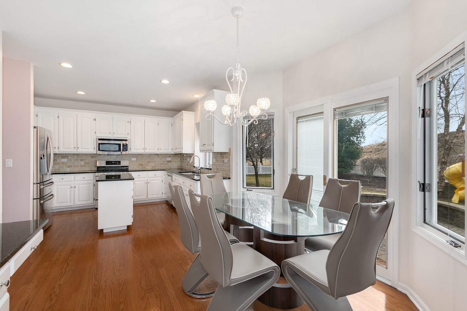 464 Lewis Road Geneva, IL 60134 - Photo 12 of 33 a view of a dining room with furniture large windows and wooden floor