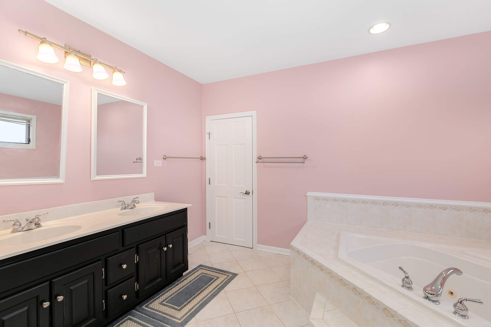 464 Lewis Road Geneva, IL 60134 - Photo 21 of 33 a spacious bathroom with a double vanity sink a mirror and a bathtub