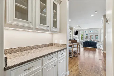 an empty room with windows and ceiling fan