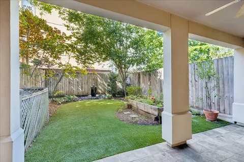 a view of backyard with large trees and a big yard