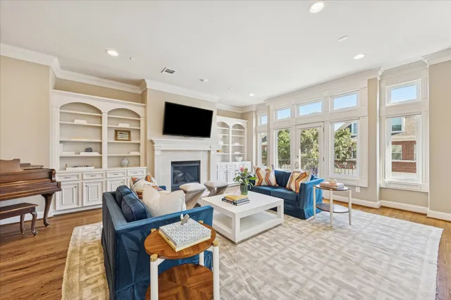 a living room with furniture a fireplace and a flat screen tv