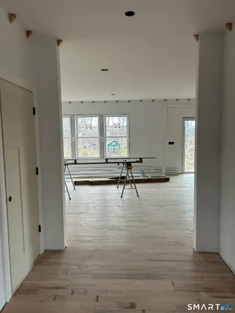 a kitchen that has a lot of cabinets in it and wooden floors