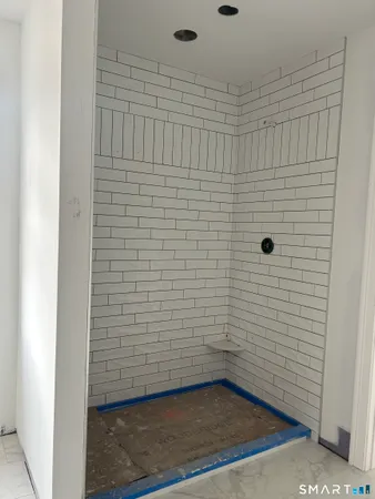 a kitchen with stainless steel appliances granite countertop a stove a sink a microwave a dining table and chairs