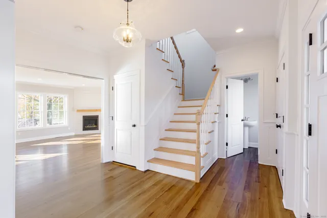 a view of a room with wooden floor and window