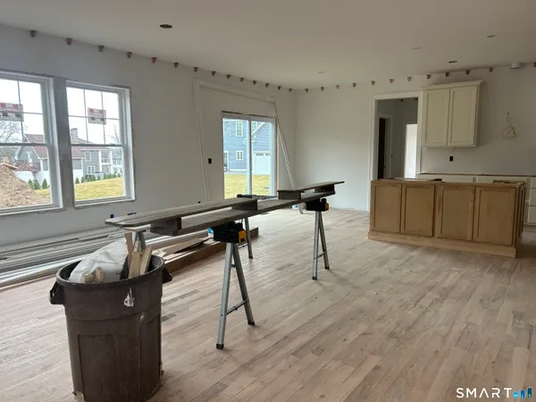 a large kitchen with a table and chairs