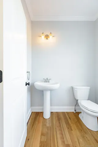 a bathroom with a sink toilet and a mirror