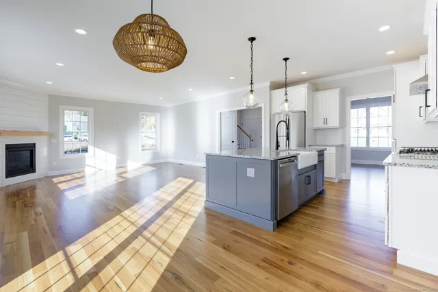 a view of kitchen with sink and wooden floor