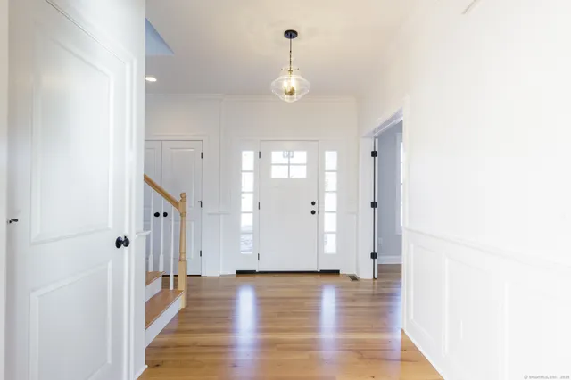 a view of a room with wooden floor and white walls