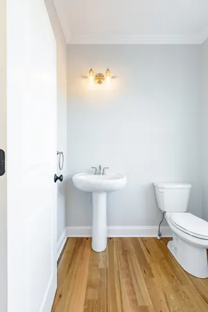 an empty room with a window and wooden floor
