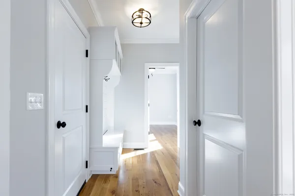 a view of a hallway with wooden floor and dining room