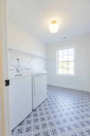 a bathroom with a granite countertop double vanity sink and a mirror