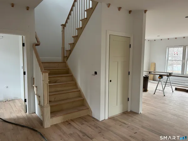 a view of entryway and hall with wooden floor