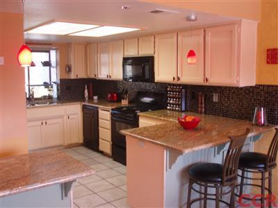 8550 Corriente Road Atascadero, CA 93422 - Photo 8 of 15 a kitchen with a stove a sink and a refrigerator