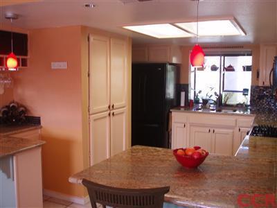 8550 Corriente Road Atascadero, CA 93422 - Photo 9 of 15 a kitchen with stainless steel appliances a dining table and a refrigerator