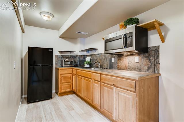 461 Talus Road Monument, CO 80132 - Photo 33 of 40 Wet bar in basement is a kitchenette!