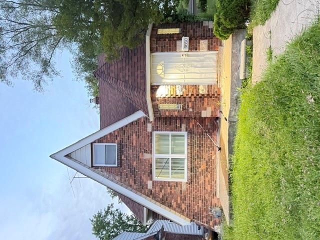 9850 Yorkshire Road Detroit, MI 48224 - Photo 1 of 9 Brick facade residence featuring a prominent gabled dormer, a turreted entry, and a covered porch