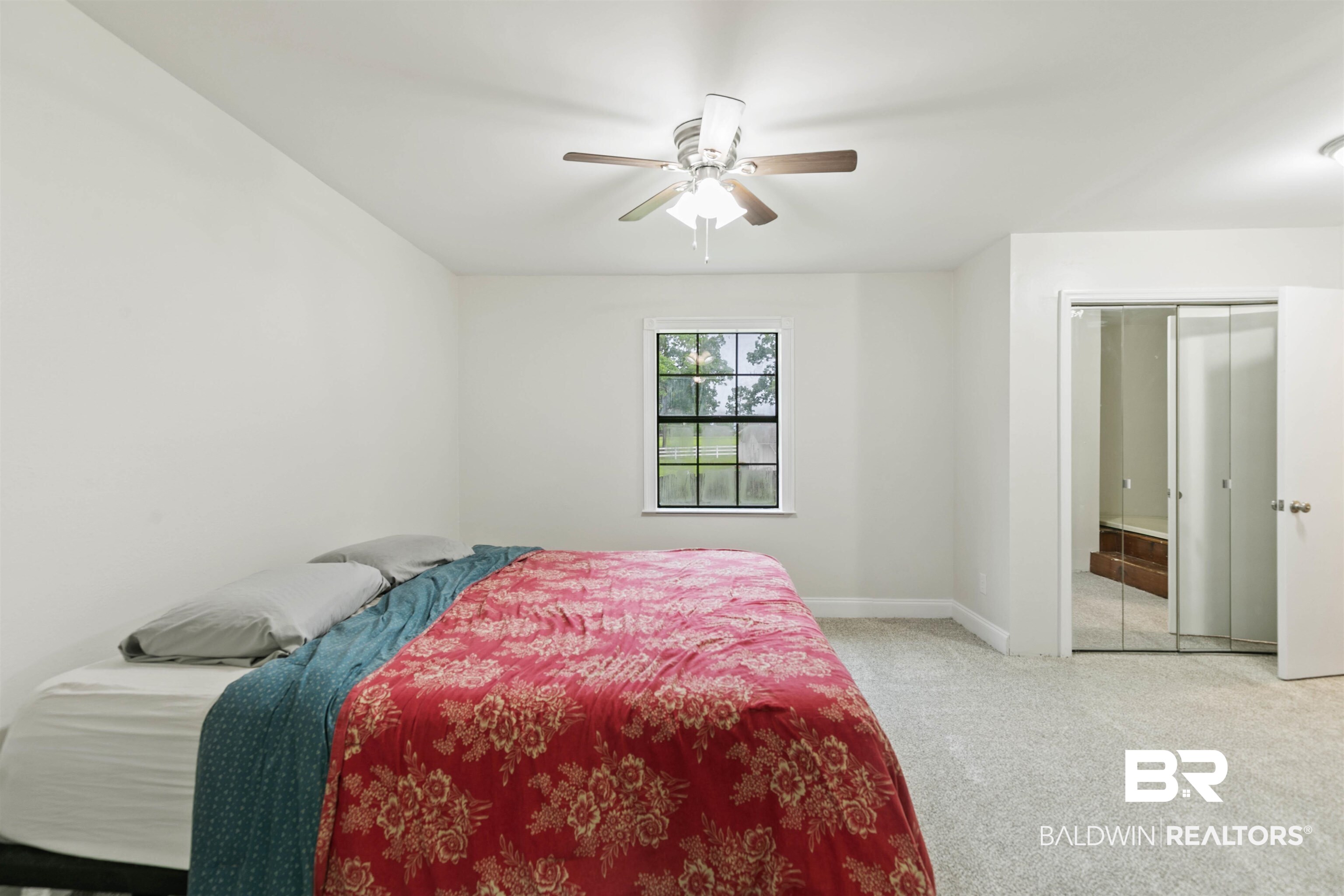 10420 Johnson Road South Mobile, AL 36695 - Photo 40 of 75 Spacious room featuring light-toned carpeting, a window with exterior tree views, and white painted walls