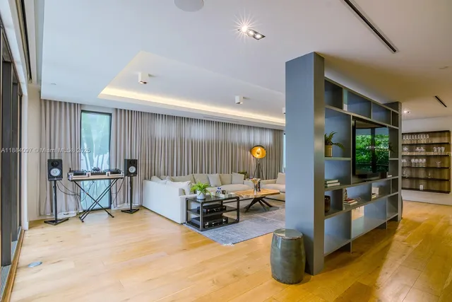 a living room with furniture and kitchen view