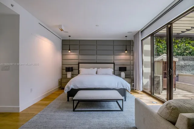 a bedroom with a bed and large window