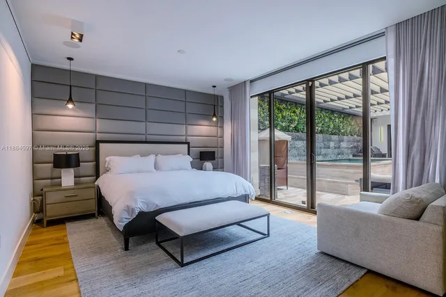 a bedroom with a bed and large window