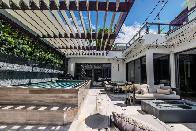 a view of a patio with table and chairs and potted plants