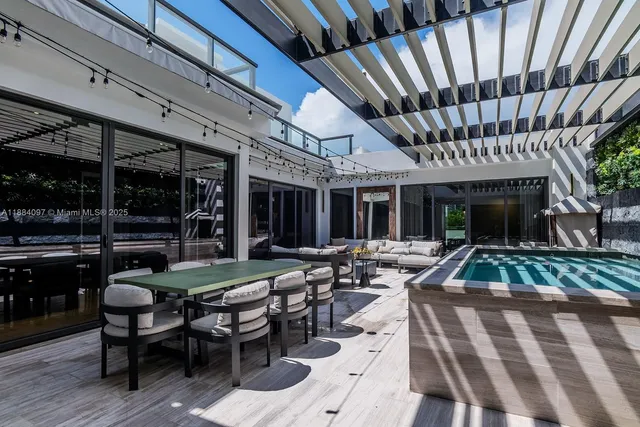 a view of a house with backyard porch and sitting area