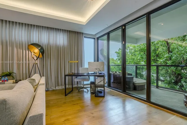 a living room with furniture and a floor to ceiling window