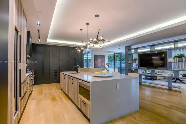 a view of living room kitchen with stainless steel appliances furniture and a window